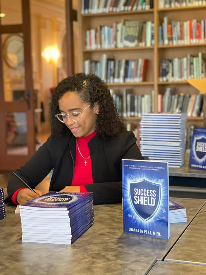 Joanna signing Success Shield
